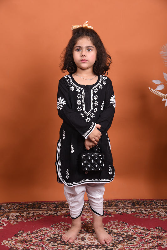 Young girl wearing a black embroidered kurta with white dhoti