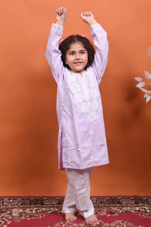 Child wearing a light purple embroidered kurta with white pants 
