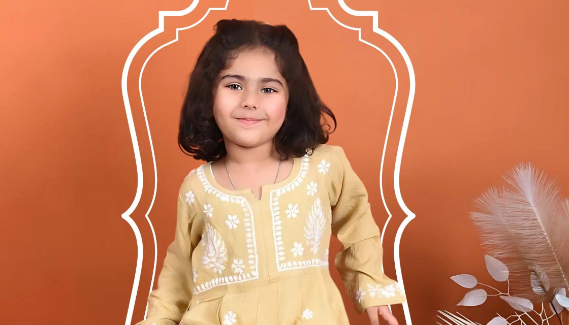 Young girl in a yellow embroidered dress against an orange background with decorative elements.