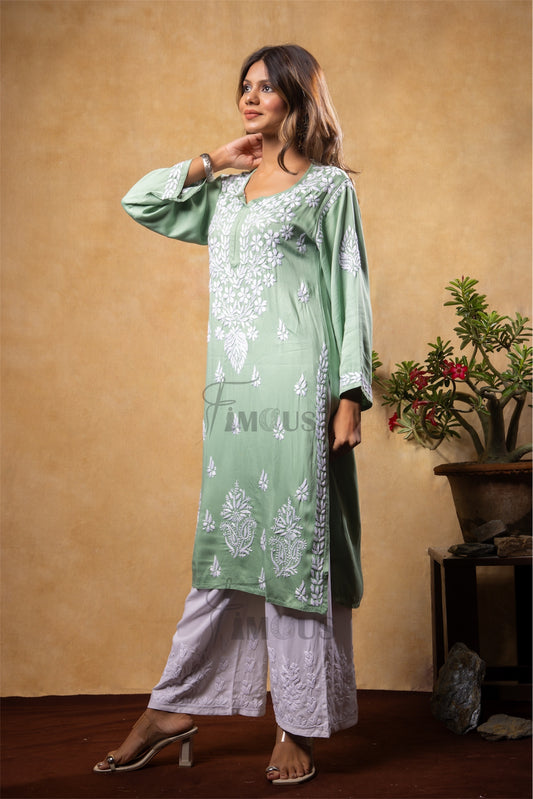 Woman wearing a green embroidered kurta with white pants in chikankari embroidery