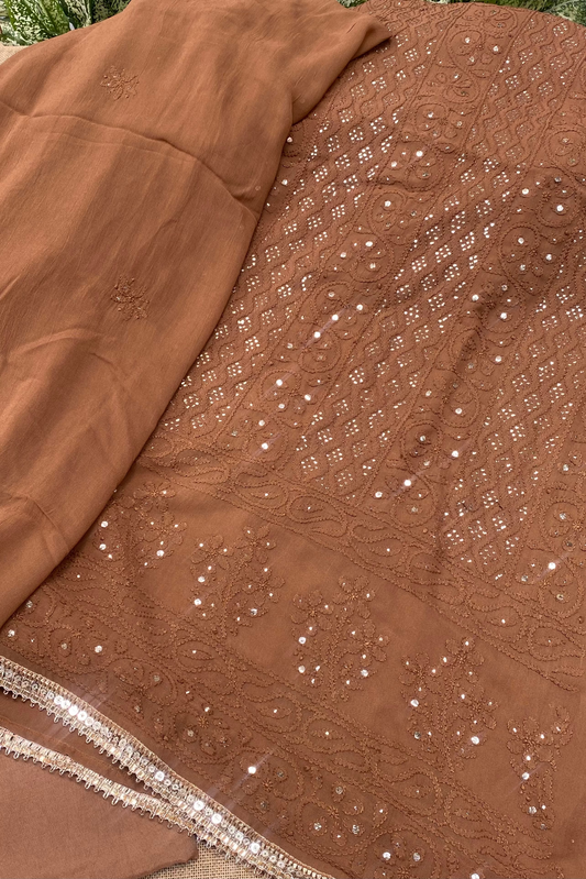 Brown fabric with intricate silver embroidery and sequins