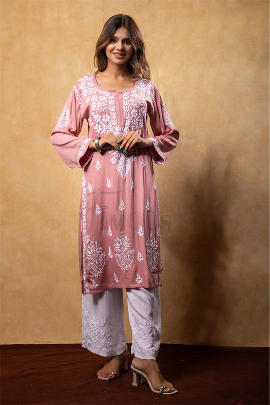 Woman wearing a pink embroidered kurta with white pants in chikankari